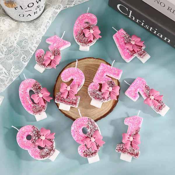 Pink sequin bow decorative birthday candles shaped like the numbers 2, 5, and 8