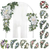 A wedding arch decoration featuring dusty rose and blue flowers and eucalyptus greenery.