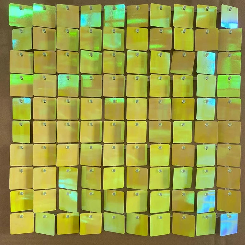 A grid of iridescent gold and green sequin shimmer wall panels used as a sparkling backdrop.