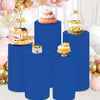 Blue elastic cylinder stands decorated with birthday cakes and balloons for party and event display