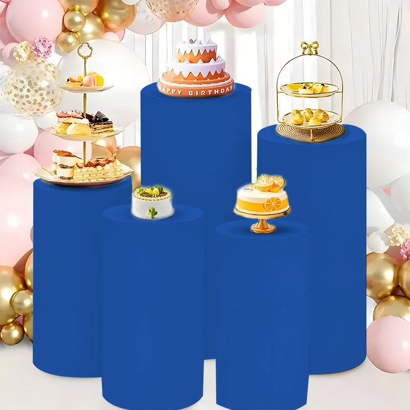 Blue elastic cylinder stands decorated with birthday cakes and balloons for party and event display