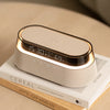 A beige wireless charging speaker lamp with a wooden base and illuminated display showing 15:30 and 69% battery life.