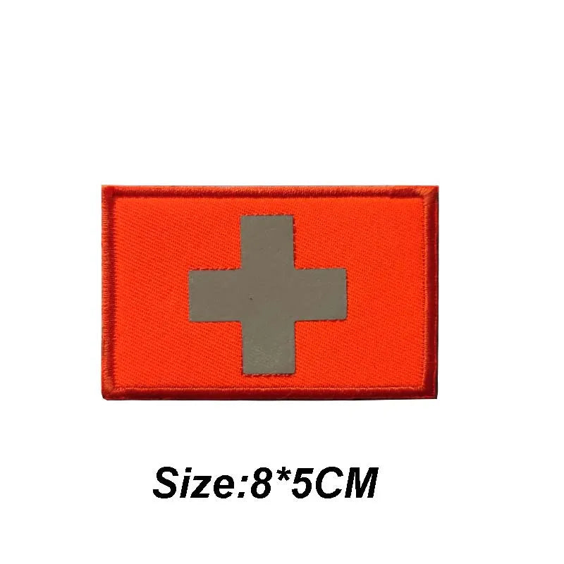 Orange tactical morale patch with a silver cross design
