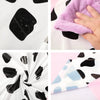 Close-up shots of a pink cow print fabric featuring black and light blue abstract shapes.