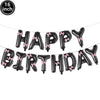 A string of black foil letter balloons spelling out HAPPY BIRTHDAY for a party decoration set.