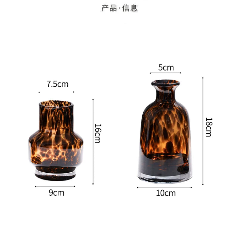 A dark amber glass vase with a leopard print pattern, shown from the side.