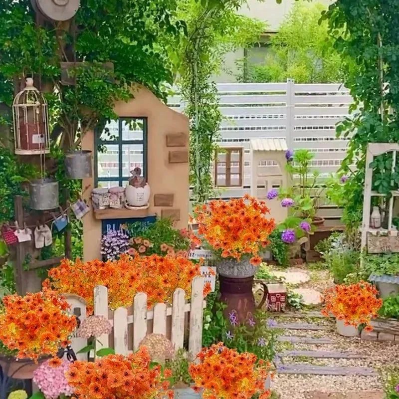 An artificial autumn bouquet featuring vibrant orange and yellow silk flowers displayed outdoors among greenery.