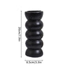 Black ceramic vase with stacked, rounded segments, shown against a white background.