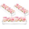 Clear acrylic rectangular vase displaying pink and peach roses arranged in multiple tiers