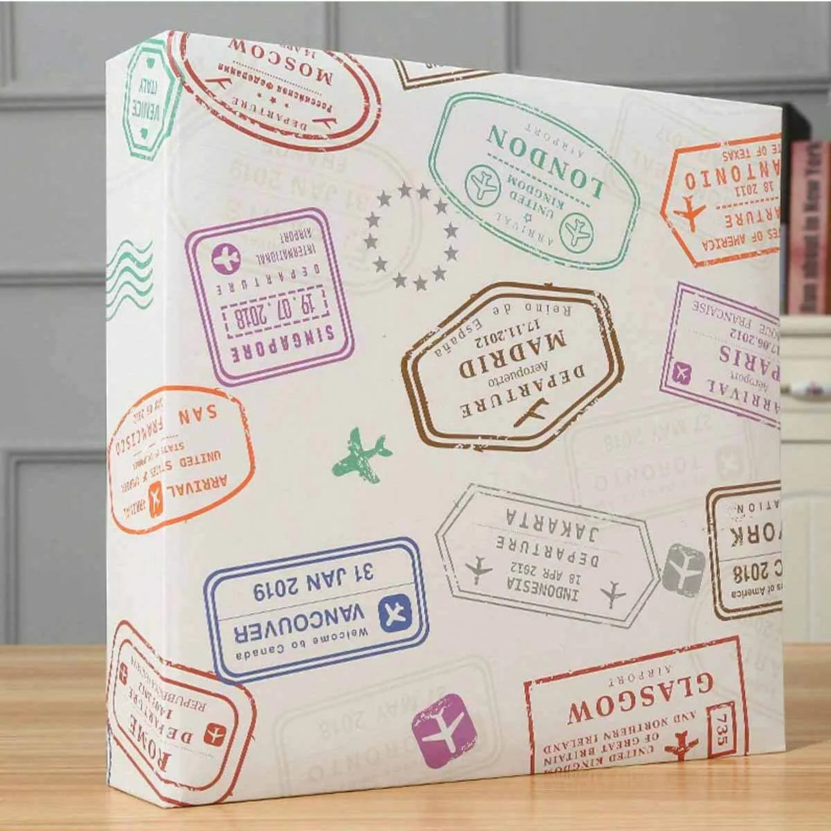 A white photo travel album with various country departure and arrival stamps and labels.