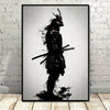 Black and white canvas wall art depicting a silhouette of a samurai with a helmet and sword against a bright background.