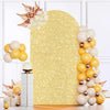 Golden arch sequin backdrop featuring light yellow and gold balloons and floral accents for events