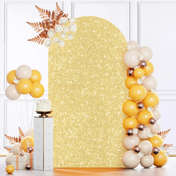 Golden arch sequin backdrop featuring light yellow and gold balloons and floral accents for events