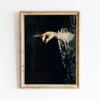 A framed dark academia vintage canvas print showing a hand delicately touching a dark surface with a lace-trimmed sleeve.