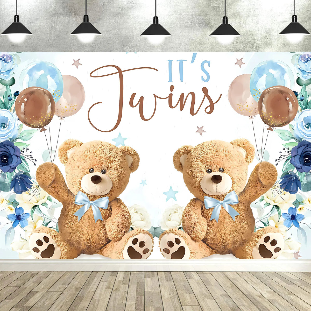 A photo backdrop featuring two cute cartoon teddy bears and blue balloons with floral accents for a baby shower.