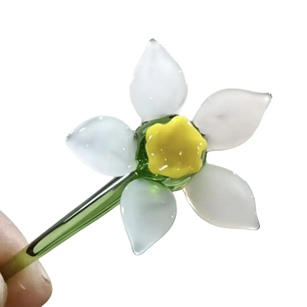 Handcrafted blue glass flower sculpture with white petals and a yellow center