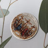 A round commemorative coin depicting a scene of the Crucifixion and Resurrection.