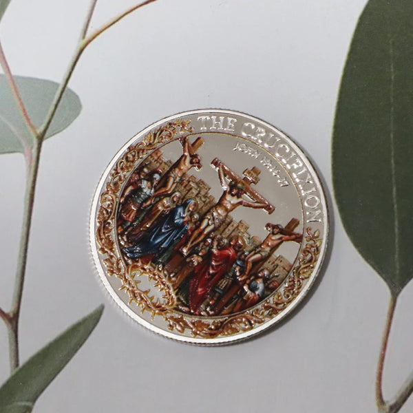 A round commemorative coin depicting a scene of the Crucifixion and Resurrection.
