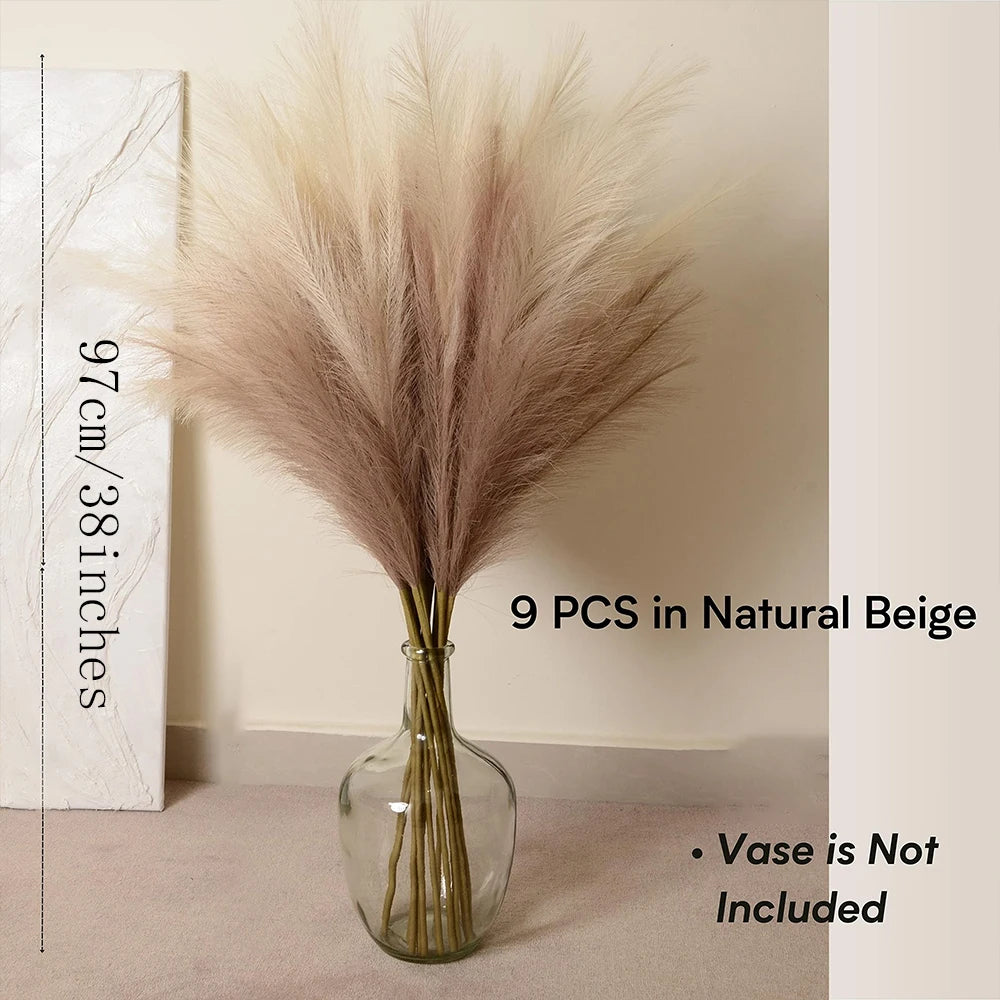 A bouquet of 9 natural beige pampas grass branches in a clear glass vase.
