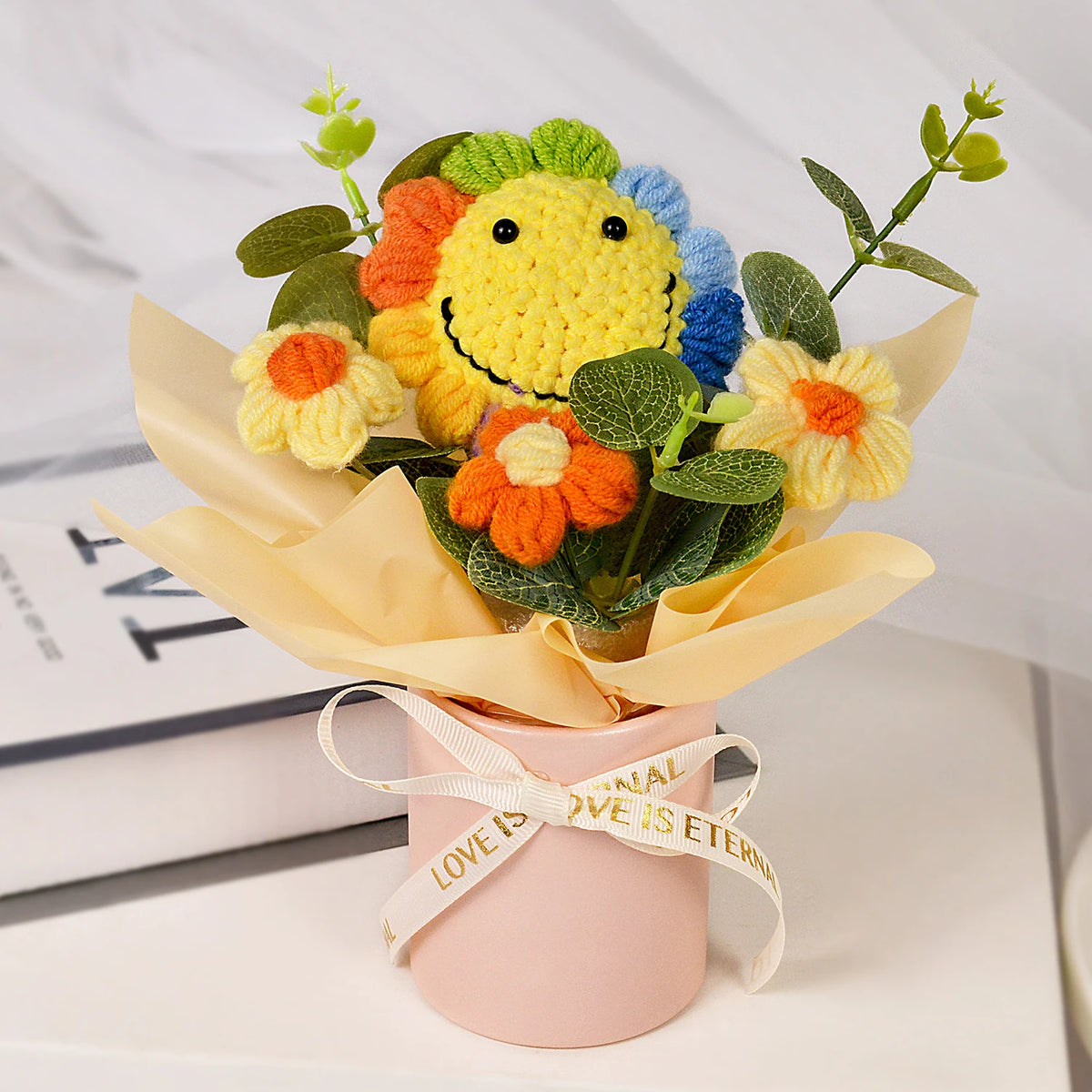 Handmade crochet sunflower bouquet with orange and yellow flowers in a pink gift box