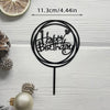 Black acrylic cake topper featuring happy birthday text and a heart on a stick