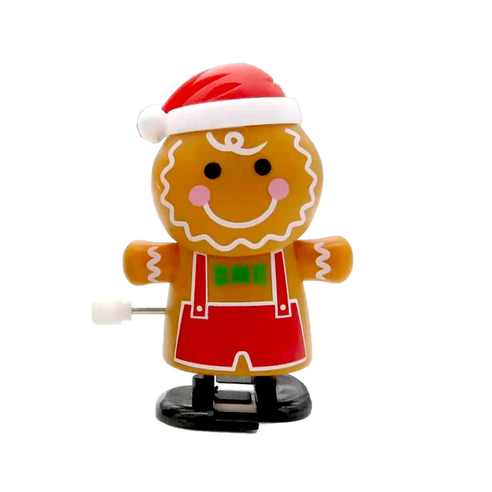A yellow clockwork wind-up figurine dressed in a Santa hat and red outfit.
