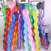 A collection of colorful spiral latex party balloons in shades of pink, green, blue, orange, and yellow.