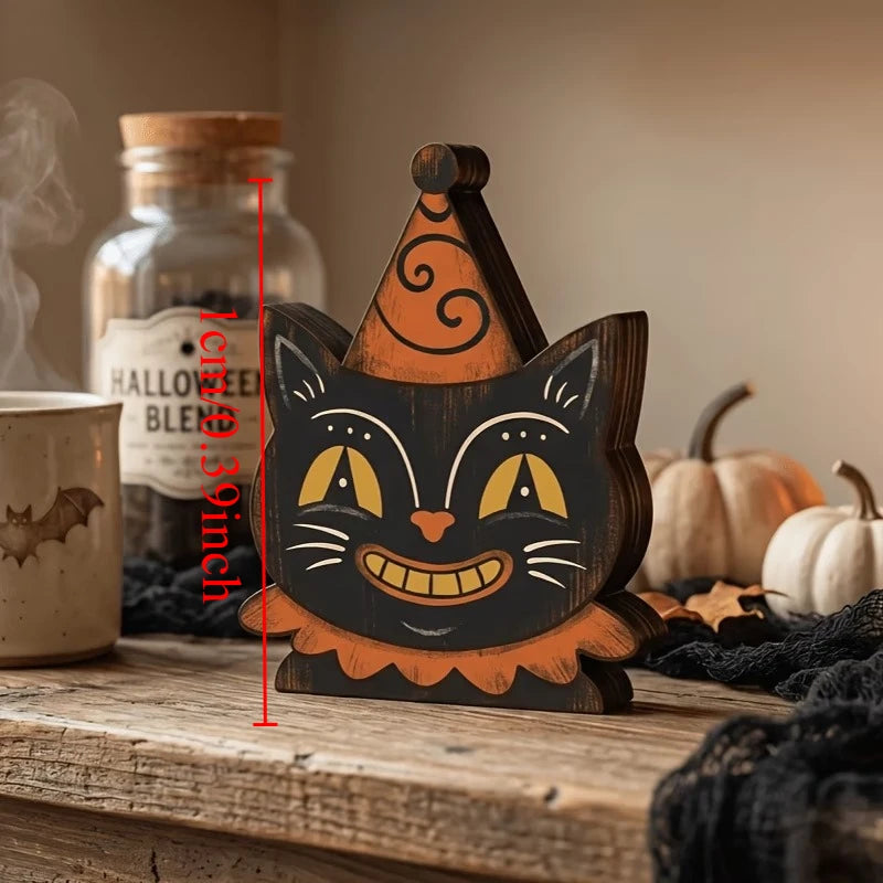A wooden cat face Halloween decor set with orange and black paint, resting on a rustic wooden surface.