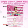 A pink and white striped flag showing a woman's portrait on the front and a faint mirrored image on the back