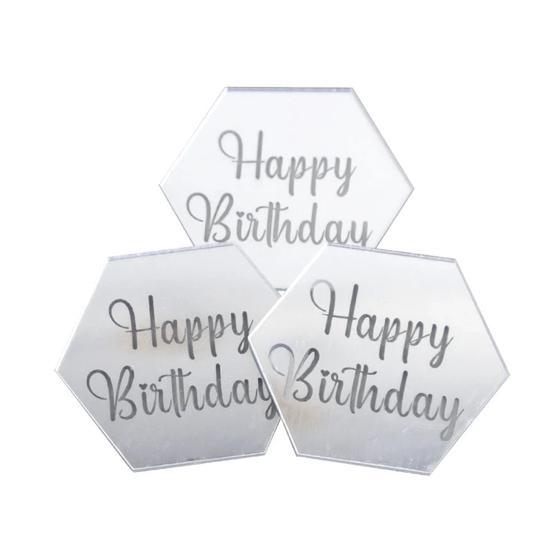 A set of ten clear acrylic birthday message toppers shaped like hexagons with silver text.