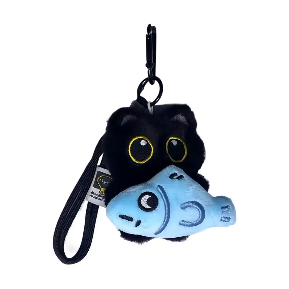 A cute seal plush keychain with black fur and a light blue face.
