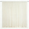 Cream colored pleated drapery backdrop hanging from a rod