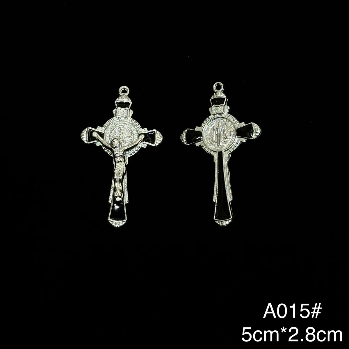 A pair of silver crucifix pendants featuring an enamel finish.
