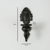 Vintage black wall-mounted double candle holder with an ornate finial and a decorative base.