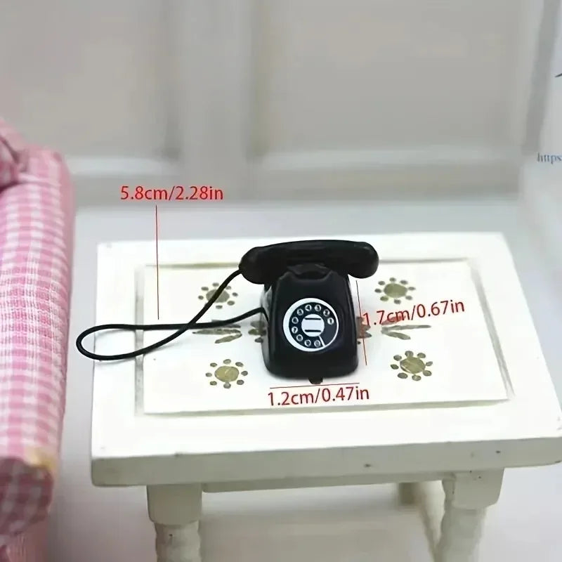 A black retro rotary desk phone miniature with a cord is displayed on a white surface.