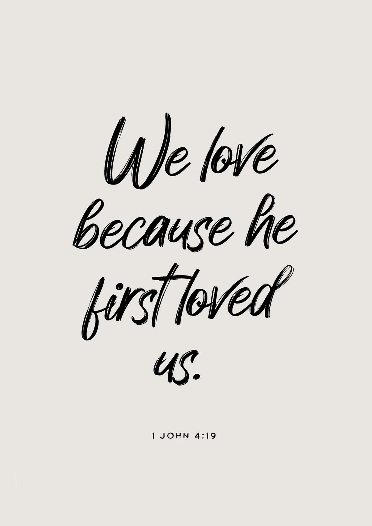 A black script quote from 1 John 4:19 on a light gray background.