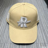 A beige baseball cap embroidered with a silver star design and white stitching on the sides.