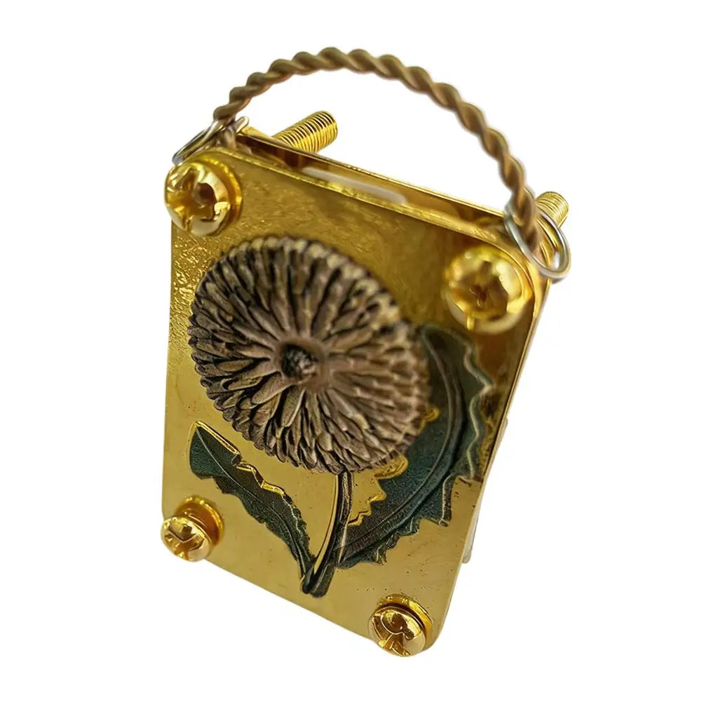 A small brass metal flower press kit with a dried flower pressed inside and a wire loop for hanging.