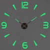 A gray clock face with bright green hour markers and a black center, showing the time is approximately 12:00.