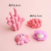 A set of pink silicone ocean animal cake toppers including a crab, turtle, octopus, whale, starfish, and shell decor.