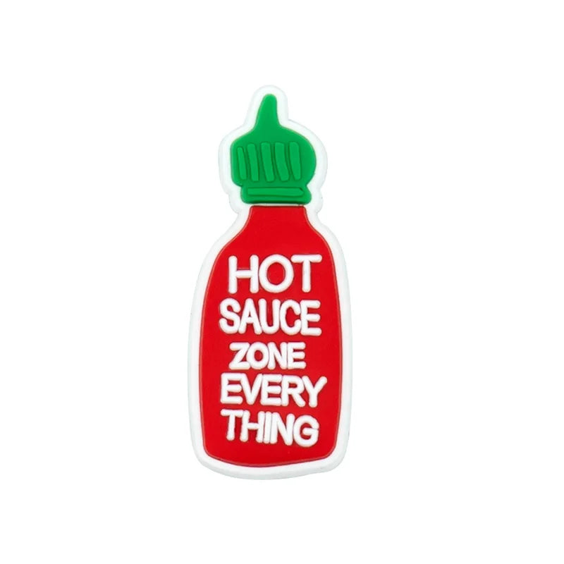 A red bottle shaped charm with a green cap labeled HOT SAUCE ZONE EVERY THING