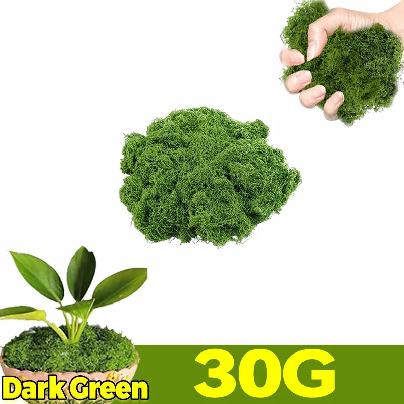 A hand holds a clump of dark green artificial moss next to a pile of the same product labeled 30G Dark Green.