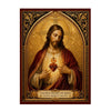 A religious painting depicting the Sacred Heart of Jesus with a flaming heart, set in an ornate gold frame.