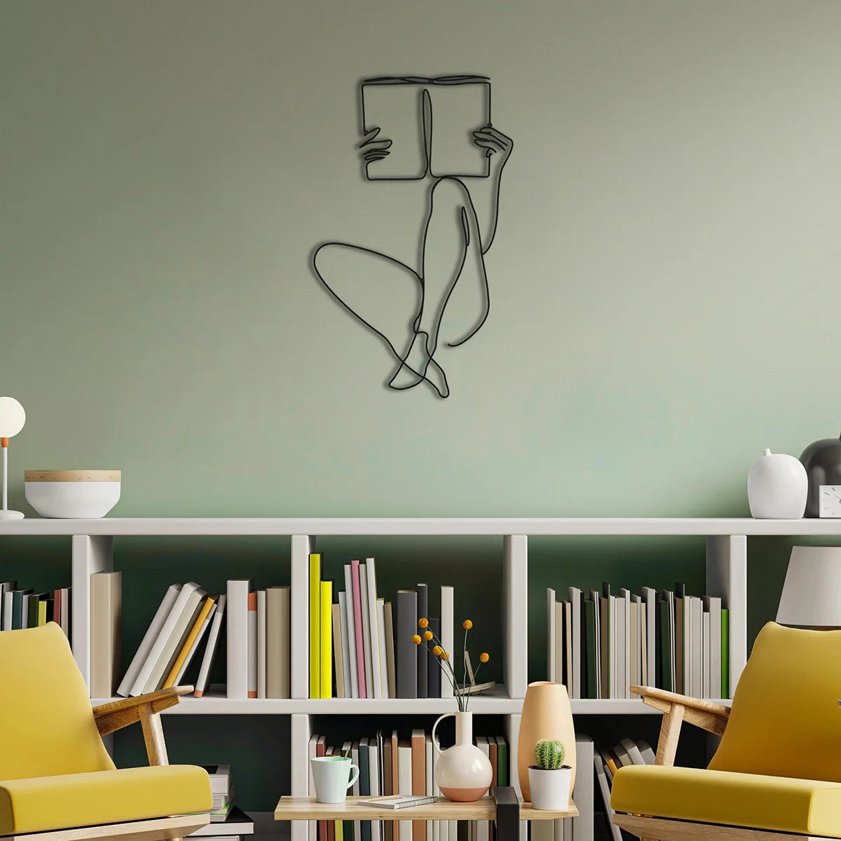 Elegant metal line art wall decor featuring a stylized figure holding a book displayed on a light green wall.