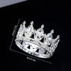 A silver crystal rhinestone crown ring shown against a black background.