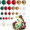 A set of twenty gold and red ball cake toppers displayed around a two-tiered green cake.