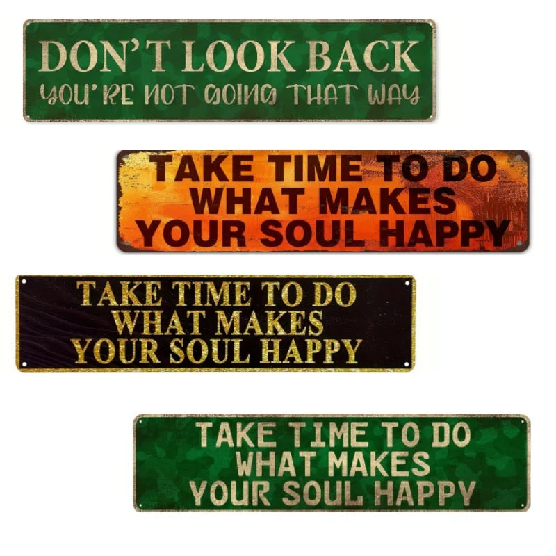 A set of four vintage metal signs with inspirational phrases on green and orange backgrounds.