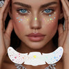 A close-up of a woman's face decorated with holographic glitter heart temporary tattoos applied around the eyes and nose.