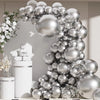 A metallic silver balloon garland arch decorated with confetti accents against a light background.