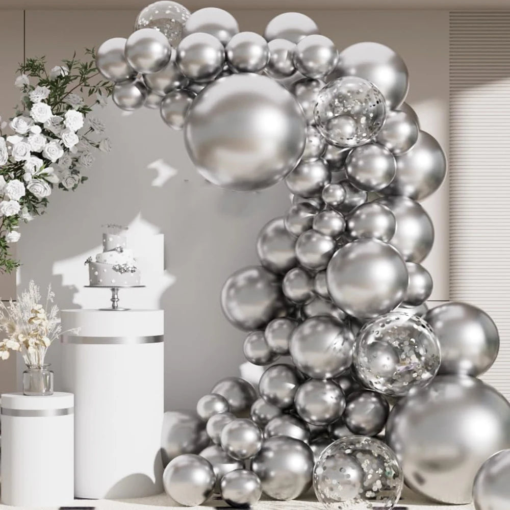 A metallic silver balloon garland arch decorated with confetti accents against a light background.